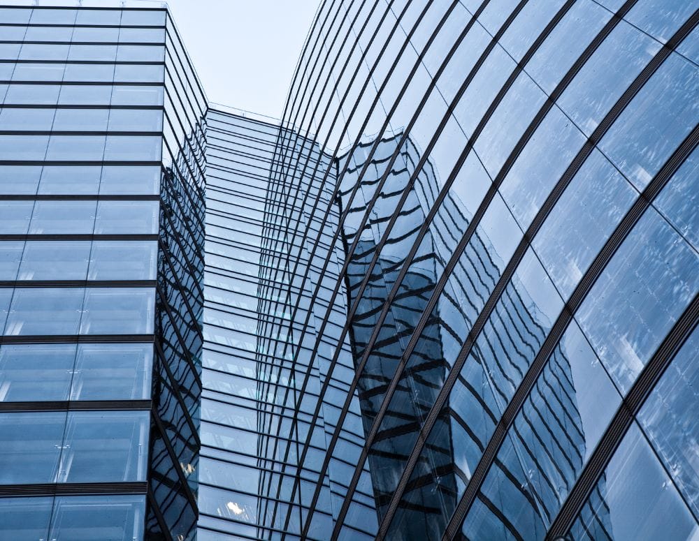 Several high rises with mirrors reflecting each other - Evergreen Building Maintenance Inc. commercial cleaning and janitorial services.