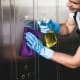 Kamloops janitorial services - man cleaning silver wall panel.