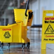 kelowna janitorial services yellow safety sign, mop and bucket on floor