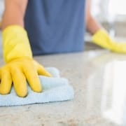 Expert Kelowna janitorial services - Woman cleaning the counter in the kitchen