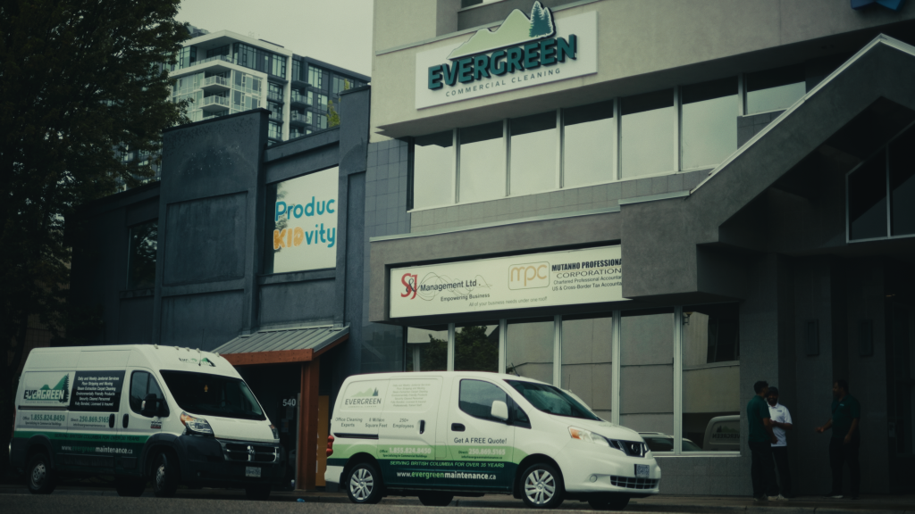 A white van parked outside of a building, ready to provide professional commercial cleaning services.