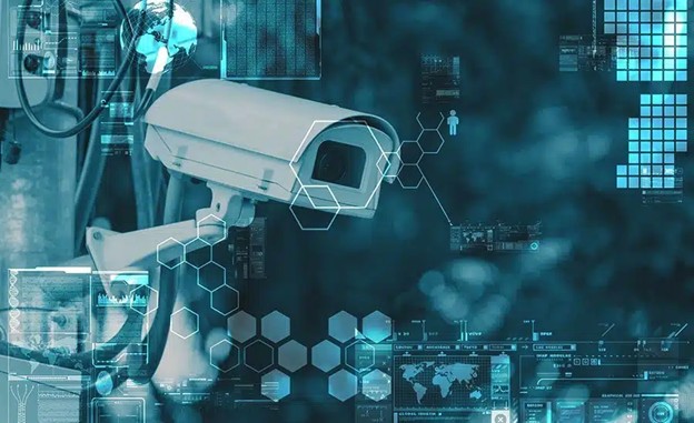 A security camera is mounted outdoors, surrounded by digital graphics including hexagons, data charts, and world maps, symbolizing surveillance, technology, and data analysis.